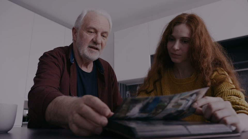 Family looking through a photo album together